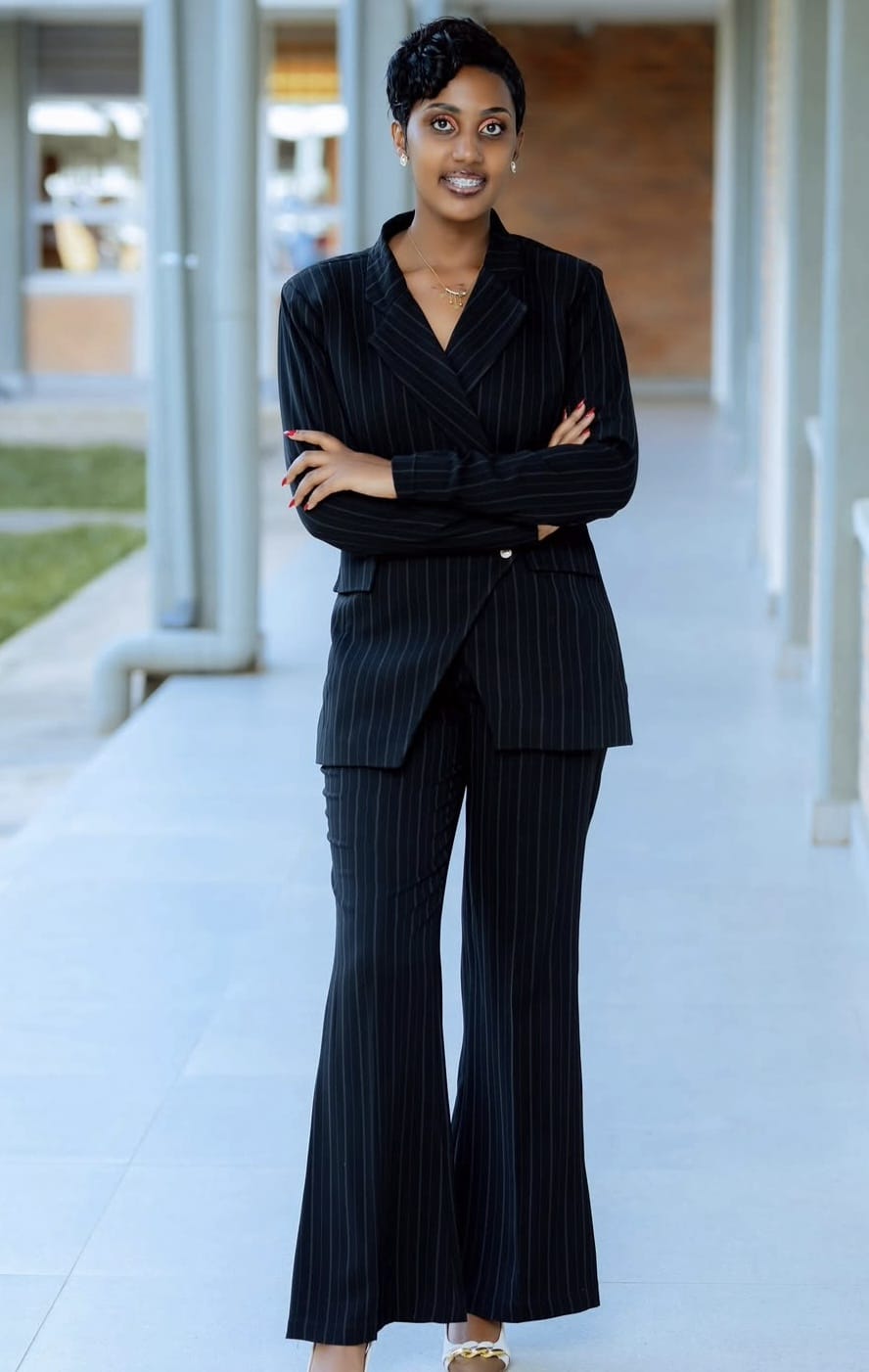 Sabine, founder of La Kuzwe, in a tailored pinstripe suit.